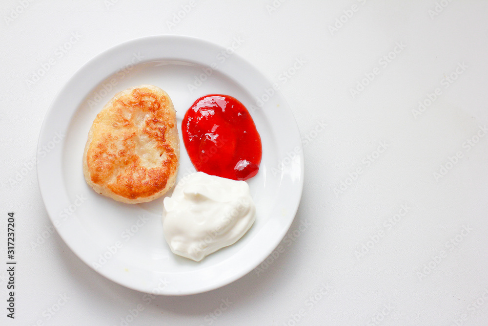 pancake, dough and jam on white saucer and on white background. Carnival concept.