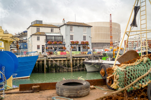 Old architecture and fisherman ships in historical dockyards of Portsmouth, Great Britain photo