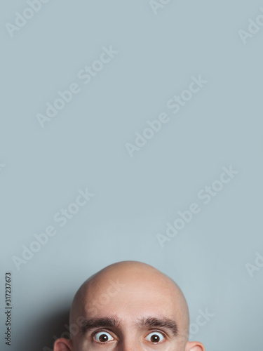 Slika na platnu Emotional portrait of surprised bald man.