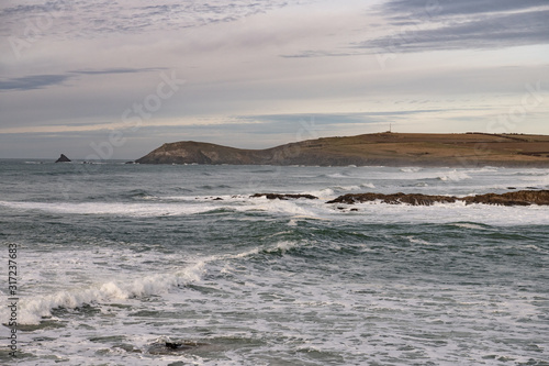 waves on a Cornish beach looking up to Trevose Head