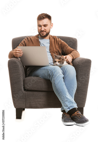 Man with cute cat and lapto...