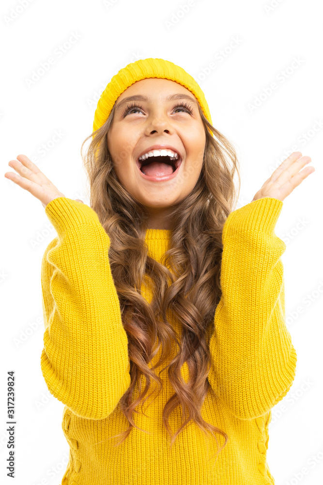 Happy caucasian girl in yellow hat and hoody rejoices isolated on white background Happy caucasian girl in yellow hat and hoody rejoices isolated on white background