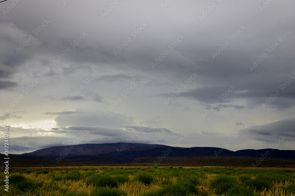 A thunder storm hanging over the mountains on the Robinson pass on its way to Oudtshoorn.