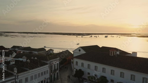 Sunset over the roofs of the old city of Faro. View from the church Largo de Se. Algarve Portugal.