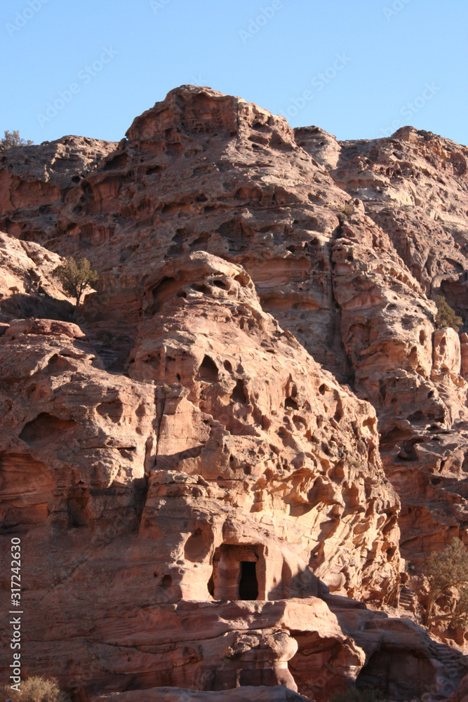 Tombs digged in red rock mountain of wonderful Petra. Jordan