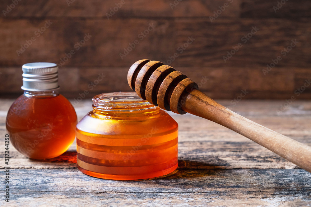 Organic honey on wooden table Organic honey on wooden table