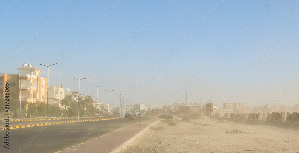 Sand storm in the desert. Dust storm on a street of the city of Hurghada, Egypt.