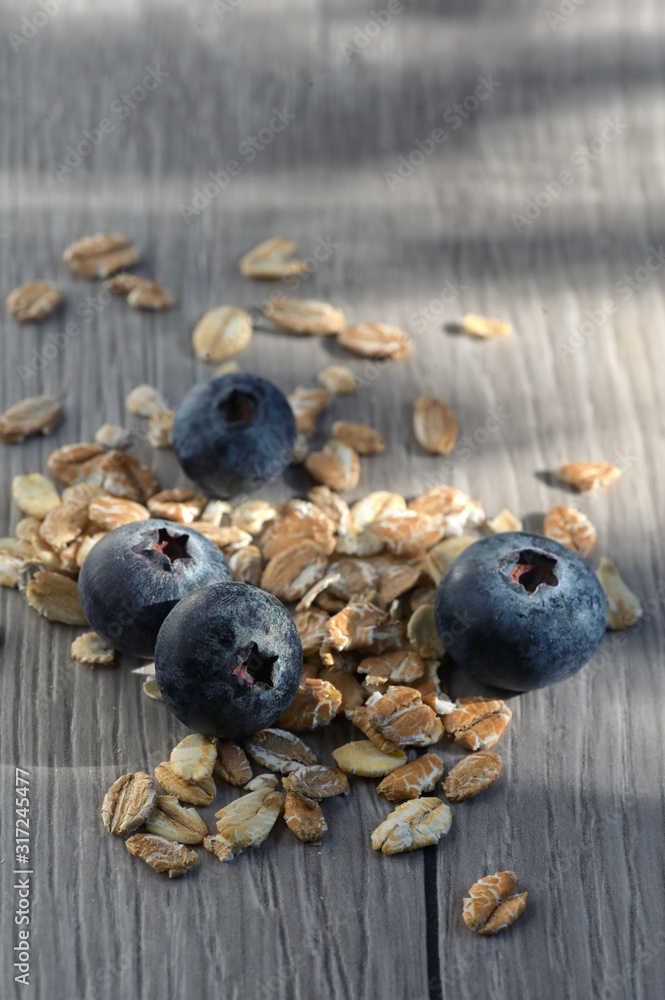 Muesli And Fresh Berries on wooden table