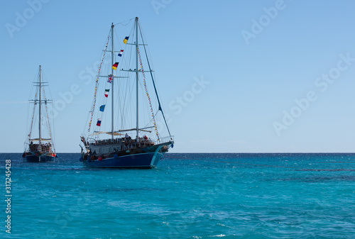 Two big ships with high masts and the surface of the Red Sea on sunny day