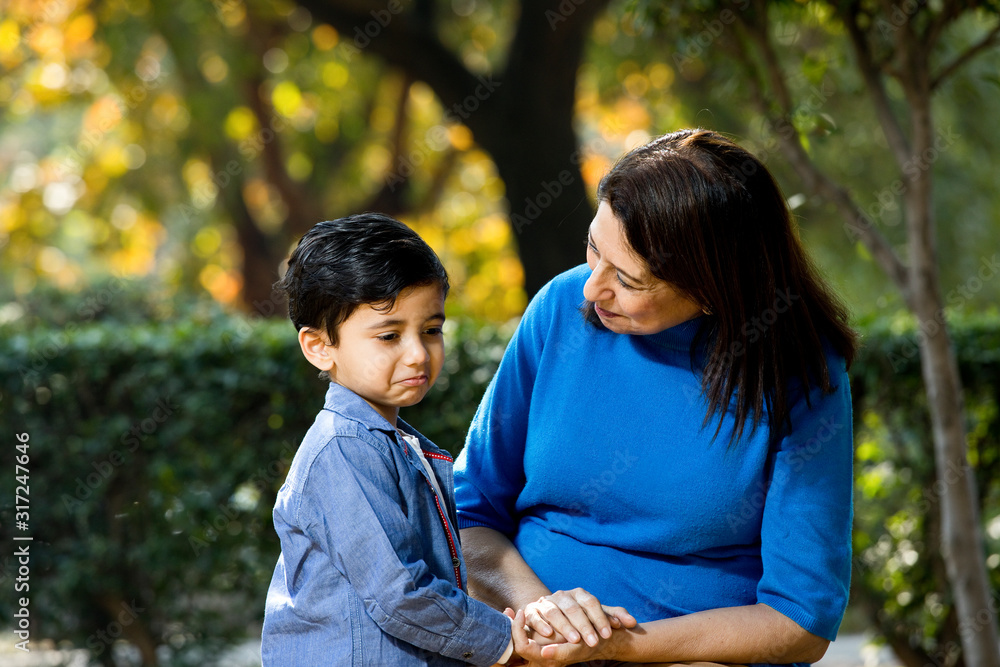 Loving grandmother playing with her grandson at park Loving grandmother playing with her grandson at park