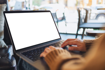 Papier peint photo  Mockup image of a woman using and typing on laptop computer with blank white desktop screen  © Farknot Architect