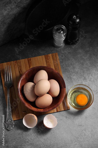 Group of of raw chicken eggs on rustic background, Ingredient for Scrambled eggs in loft style kitchen