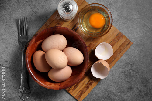 Group of of raw chicken eggs on rustic background, Ingredient for Scrambled eggs in loft style kitchen