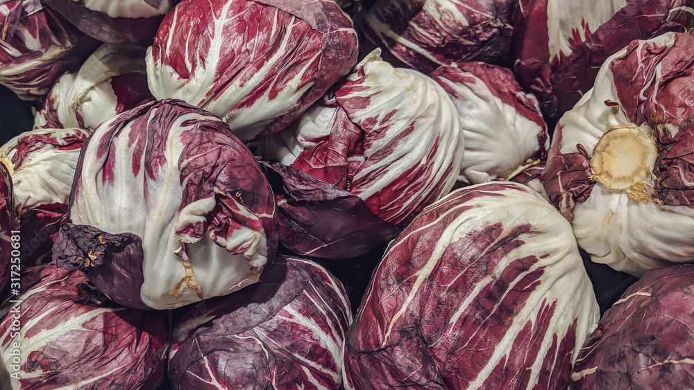 Fototapeta premium Healthy purple violet and white cabbage heads as organic vegetable in a grocery store market for sale as a part of a healthy vegan diet