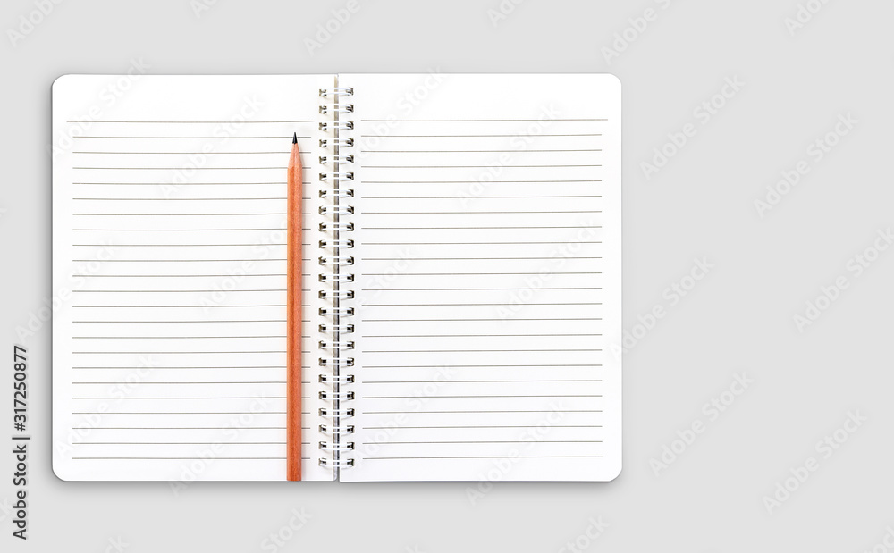 Blank notebook and brown color pencil on grey colour background. Blank notebook and brown color pencil on grey colour background.