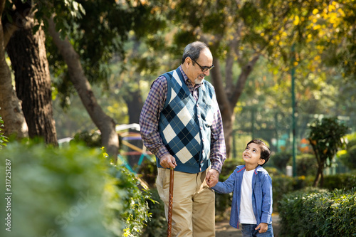 Cheerful grandfather spending leisure time with grandson