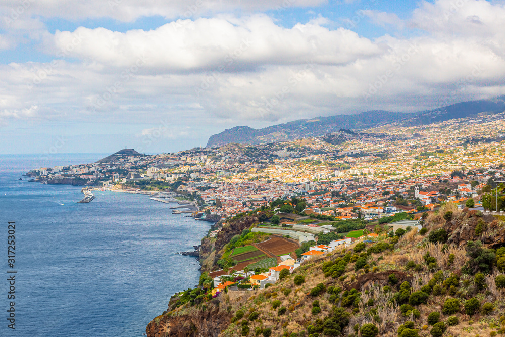 Panoramic picture over the capitol city of Funchal on the Portugese island of Madeira at daytime