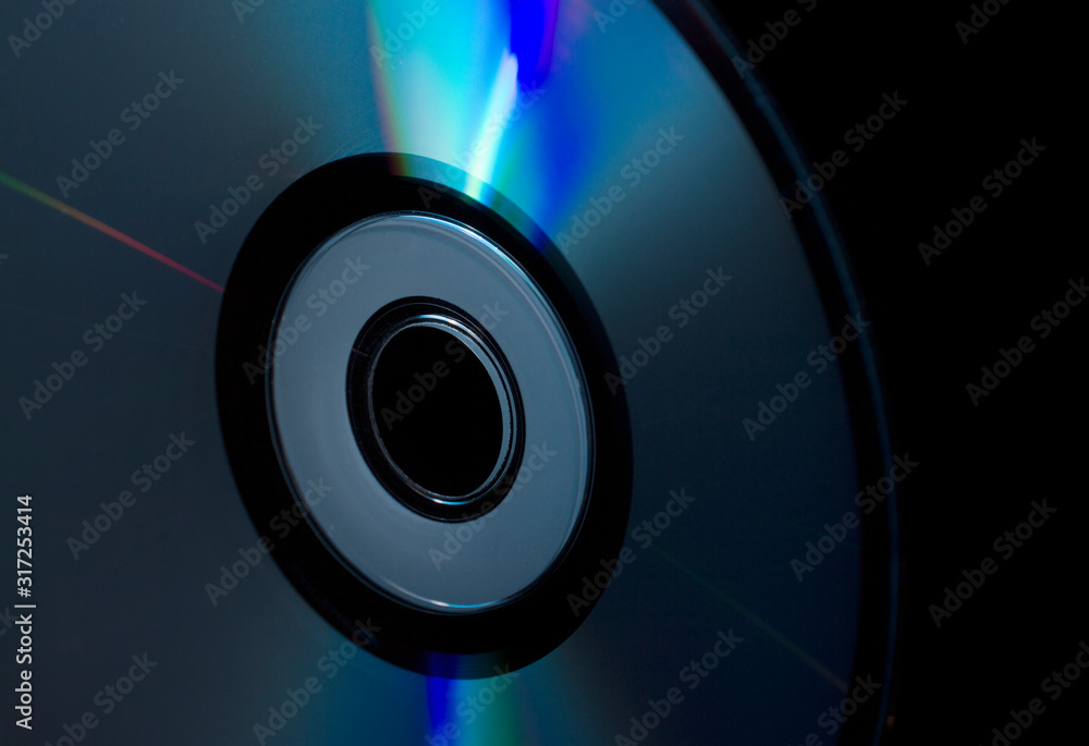 compact-disc in hand on a black background compact-disc in hand on a black background