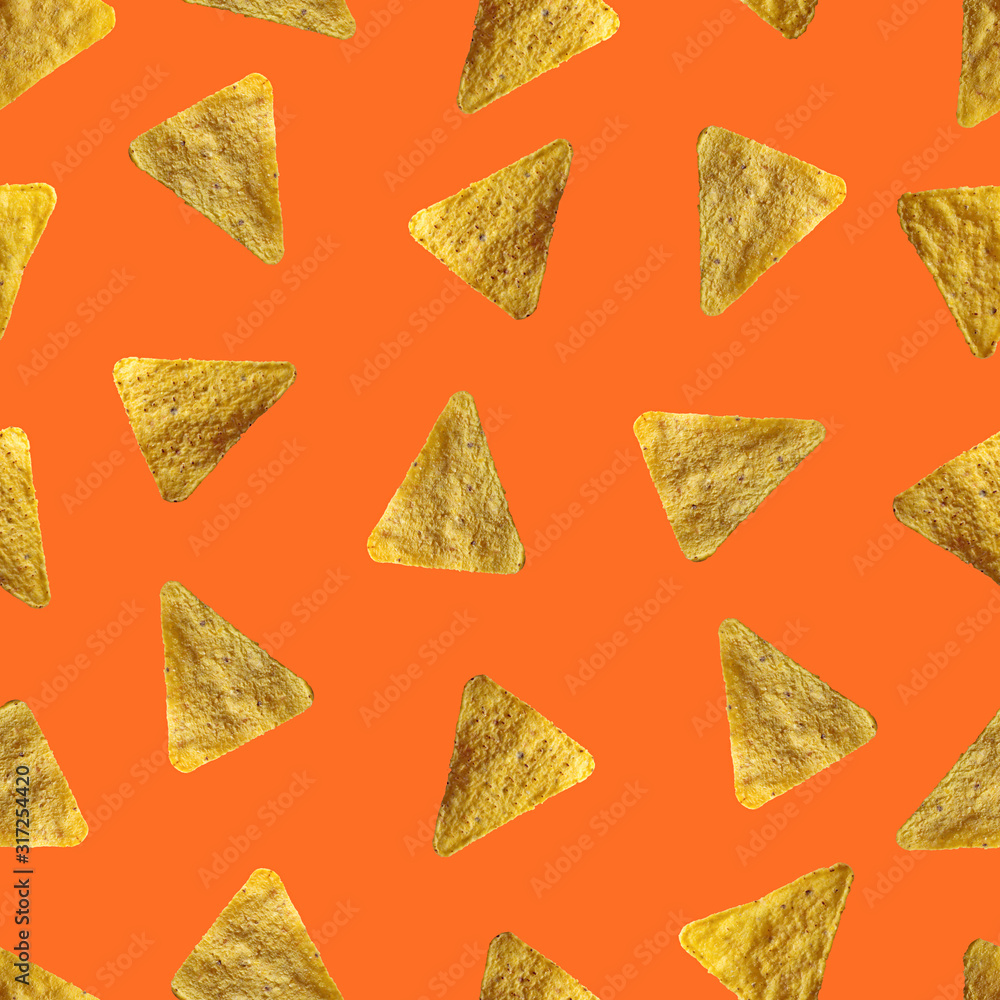Tortilla chips isolated on orange background. Seamless pattern. Tortilla chips isolated on orange background. Seamless pattern.