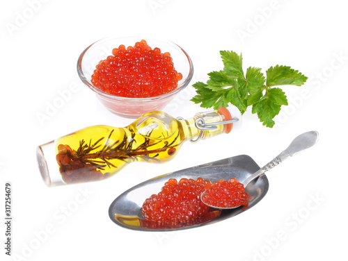 Red caviar ,green spices, silver spoon,isolated on white background .Selective focus .