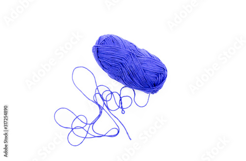 ball of blue tangled threads on a white background photo