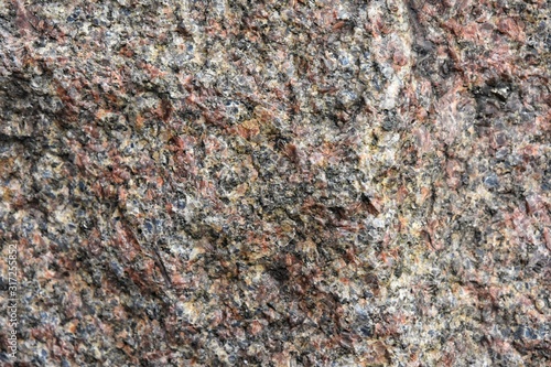 Structured granite surface with selective focus. Stone background with rough texture. Natural unpolished stone. Building materials. Marble 
