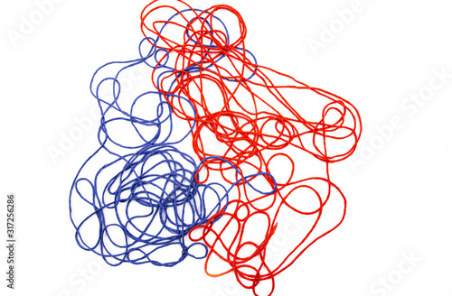 bright red and blue tangled threads on a white background photo