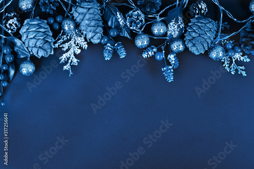 Fototapeta Naklejka Na Ścianę i Meble -  Garland, forest pinecones, berries and leaves in trendy classic blue color of the year.