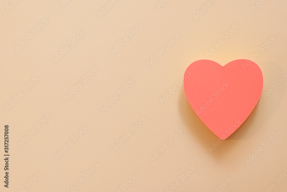 Heart shape paper note with a pen. Copy space