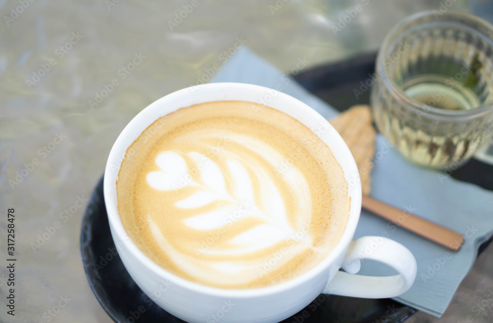 Closeup glass of latte art coffee tulip shape on wood background with vintage color, selective focus Closeup glass of latte art coffee tulip shape on wood background with vintage color, selective focus