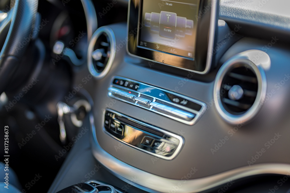 Modern media display in the interior of the car. Close-up of the dashboard technology adjustment of the blower, air conditioner, player. modern car interior