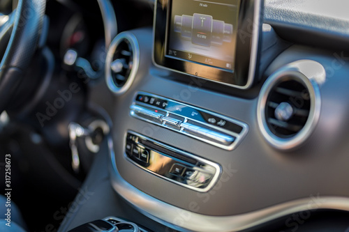 Modern media display in the interior of the car. Close-up of the dashboard technology adjustment of the blower, air conditioner, player. modern car interior