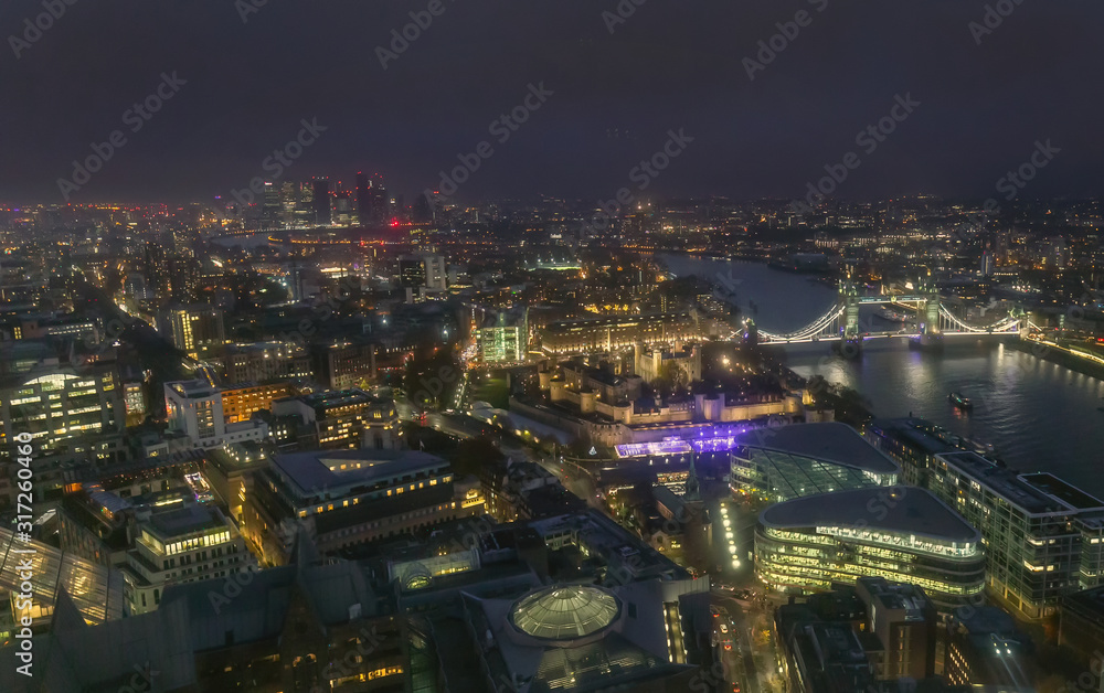 Night aerial view of Tower Bridge and City of London, England