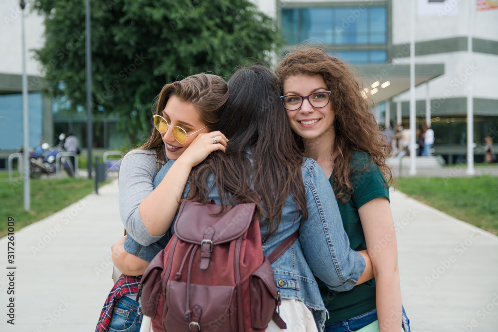 College girls hugging on a campus