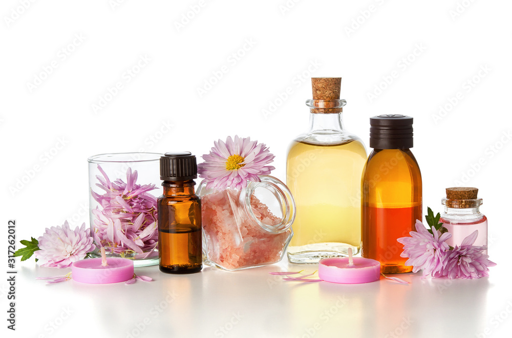 SPA aromatherapy essential oil in medical glass bottles with chrysanthemum flowers and bath salt isolated on white background SPA aromatherapy essential oil in medical glass bottles with chrysanthemum flowers and bath salt isolated on white background