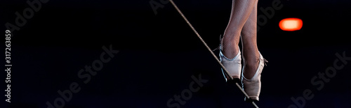panoramic shot of aerial acrobat walking on tip toe on rope
