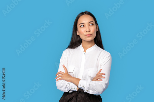 Freestyle. Young woman wearing shirt and skirt standing isolated on blue crossed arms thinking of creative idea smiling joyful © Viktoriia