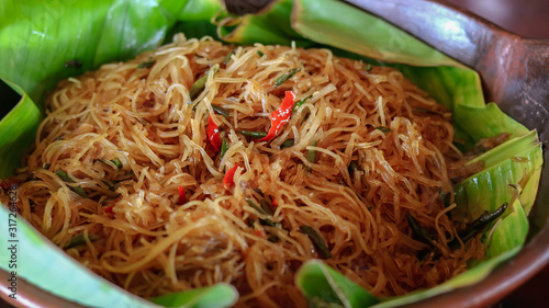 Traditional indonesian culinary food. Bihun goreng or Oseng bihun is sweet and spicy fried Vermicelli mix eggs  photo