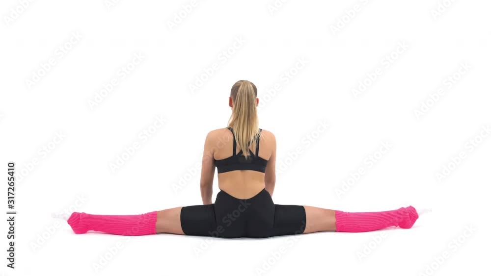 Back view of a professional sportswoman performing complex gymnastic exercise. Stretching exercises demonstration. Isolated, on white background Back view of a professional sportswoman performing complex gymnastic exercise. Stretching exercises demonstration. Isolated, on white background