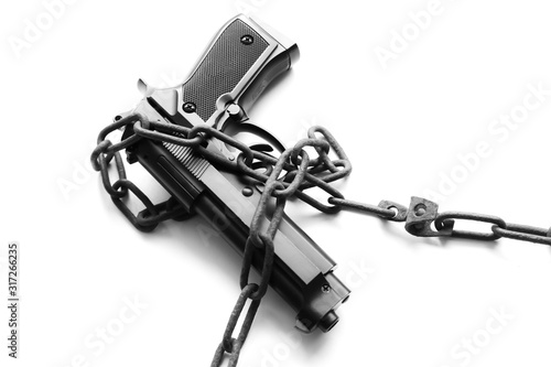 Gun and money in old rusty chains. Arrested for illegal crime. Broken the law. Criminal concept.