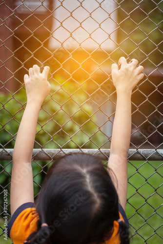 Girl hand on the wire fence, girl trying to escape, finding freedom © sirirak