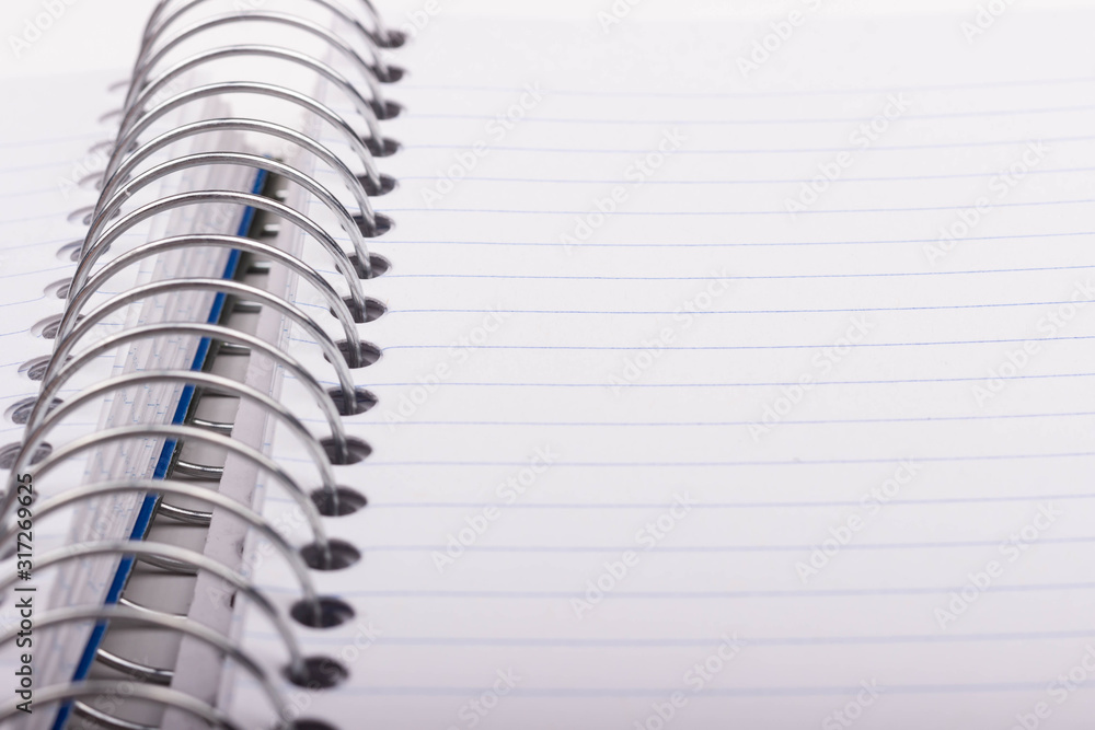 A spiral-bound notebook paper with blue lines. A spiral-bound notebook paper with blue lines.
