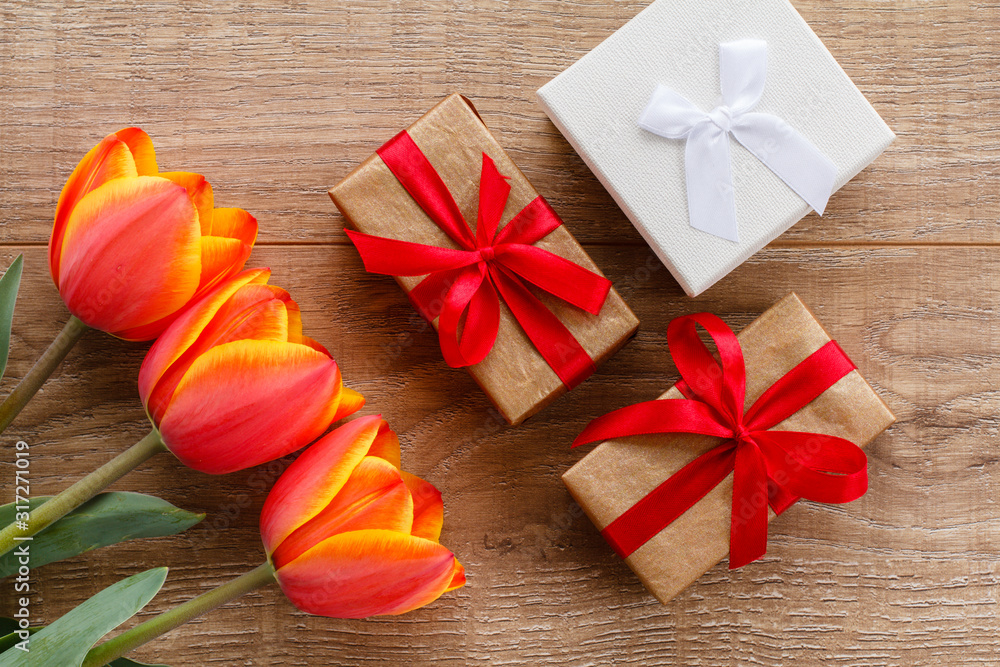 Gift boxes with red ribbons on wooden boards. Gift boxes with red ribbons on wooden boards.