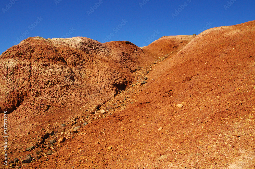 Natural red mountains in spring in Kyzyl-Chin valley, also called as Mars valley. Altai, Siberia, Russia