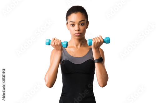 Woman Exercising Doing Dumbbell Biceps Curls On White Studio Background