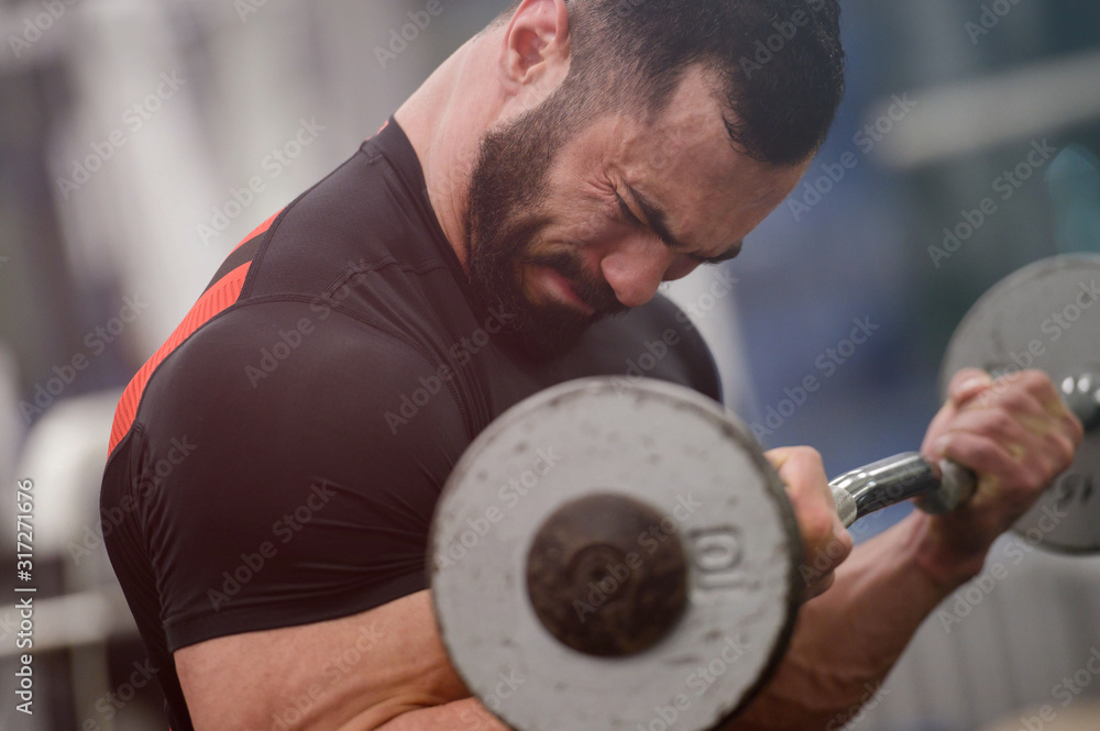 heavy painful lifting of iron barbell by young strong man with beard great mind motivation and concentration dedication with grimace of effort and pain on face heavy painful lifting of iron barbell by young strong man with beard great mind motivation and concentration dedication with grimace of effort and pain on face
