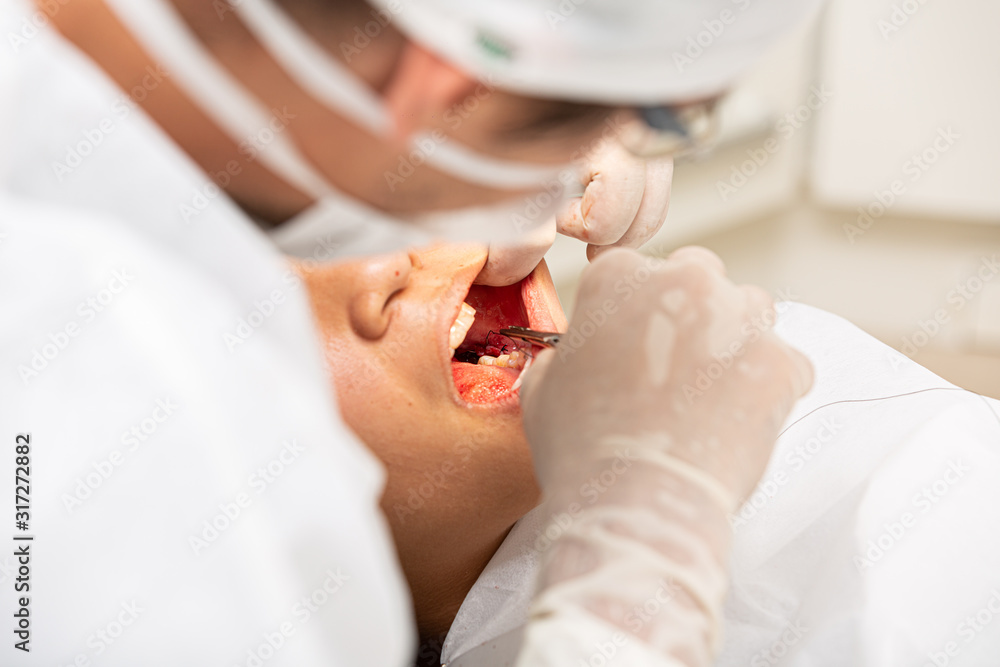 Young woman being seen in a dentist's office. Concept of toothache