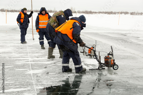 Wallpaper Mural Workers cut ice blocks to the size of ice on a frozen lake Torontodigital.ca