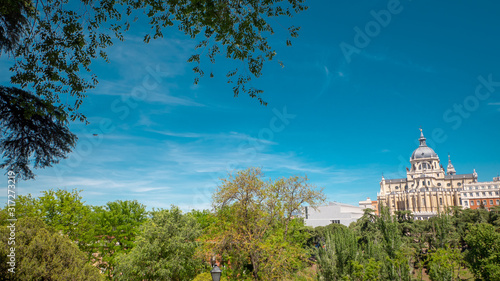 Panoramic view of Almudena cathedral from the famous park Las Vistillas in the downtown Madrid, Spain on a sunny day during the traditional festival in May called San Isidro in the capital of Spain photo