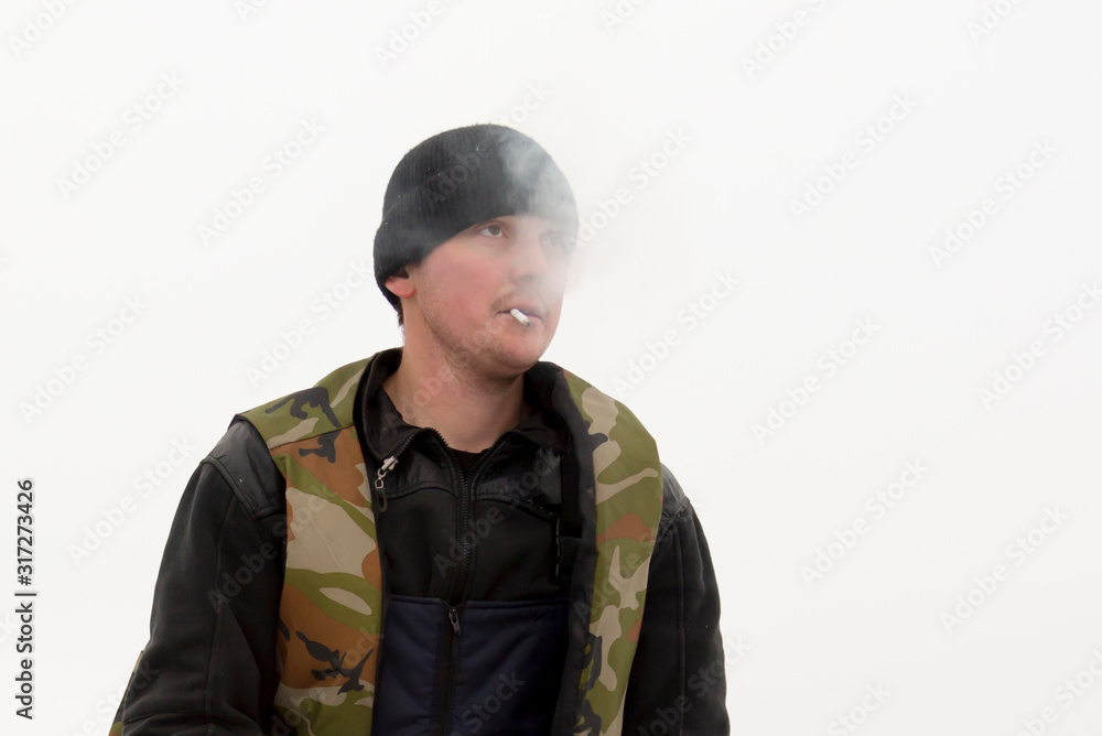Portrait of a fitter with a cigarette in his mouth Portrait of a fitter with a cigarette in his mouth